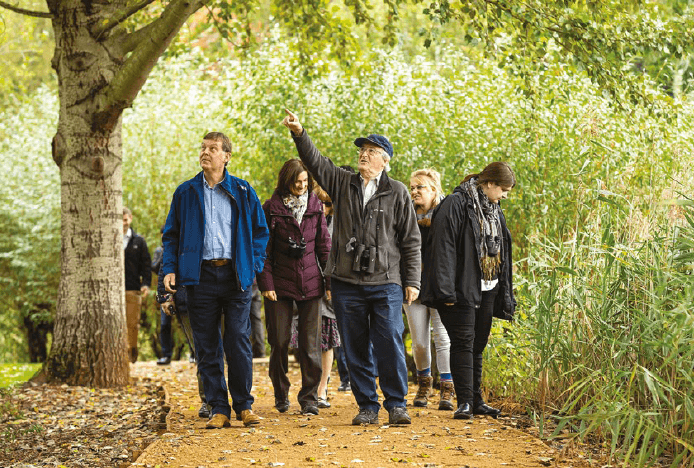 Staff and tenants on a walking tour to spot wildlife around Green Park, Reading, the UK.
